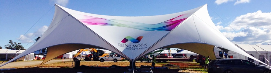 Custom branded tensioned event structure with printed canopy, engineered logo tent for large-scale corporate events and brand activations.