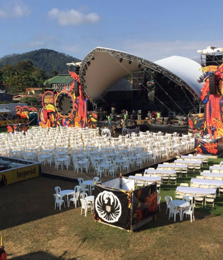 Large clear-span festival tent structure set up for outdoor concerts and live events.