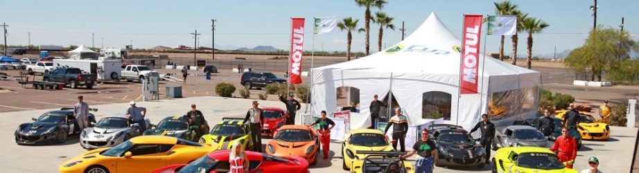 Large custom branded event tent with logo, professional canopy structure anchoring corporate automotive brand activation at outdoor event.