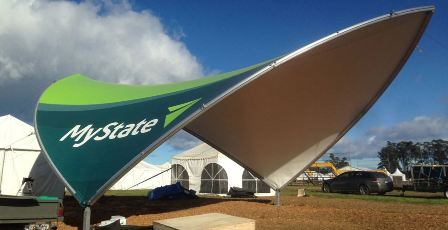 Custom logo event tent with tensioned canopy structure, branded promotional installation for festivals and corporate marketing.