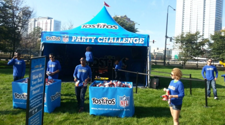 Branded event tent supporting interactive experiential marketing activation at corporate outdoor event.