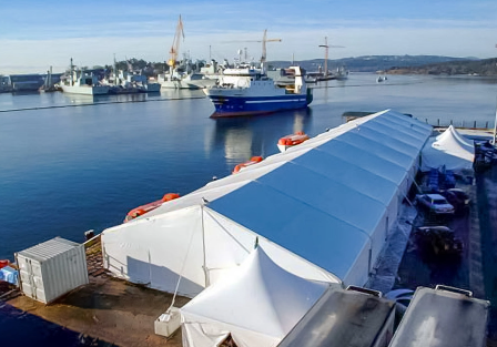 Large Tentnology fabric structure installed beside a working harbour
