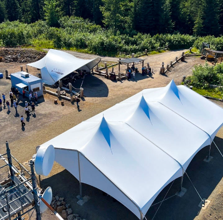 Large white fabric event structures installed at an outdoor venue