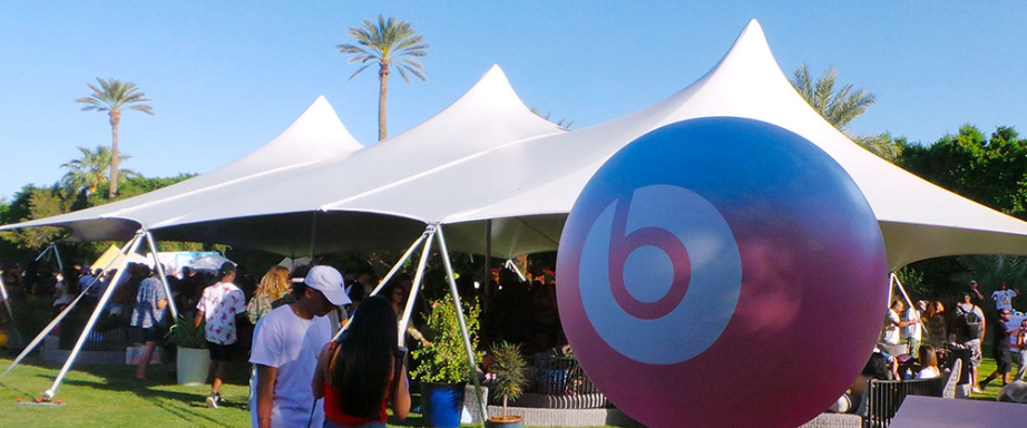 Large white tension fabric structure covering an outdoor event