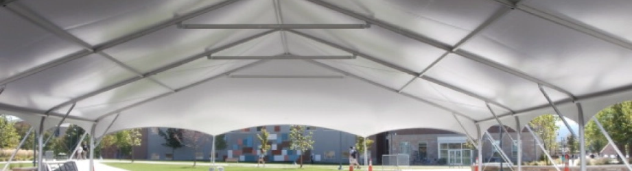 Heavy-duty portable fabric shelter with clear-span interior