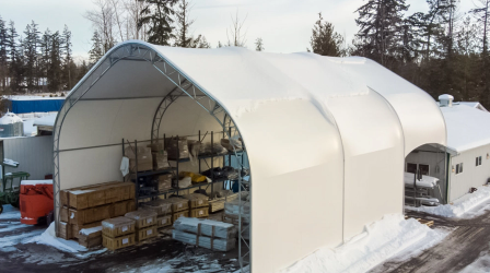 Large industrial construction tent providing covered workspace on a jobsite