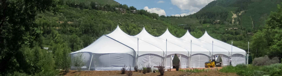 Large white Tentnology fabric structure installed in a mountain valley